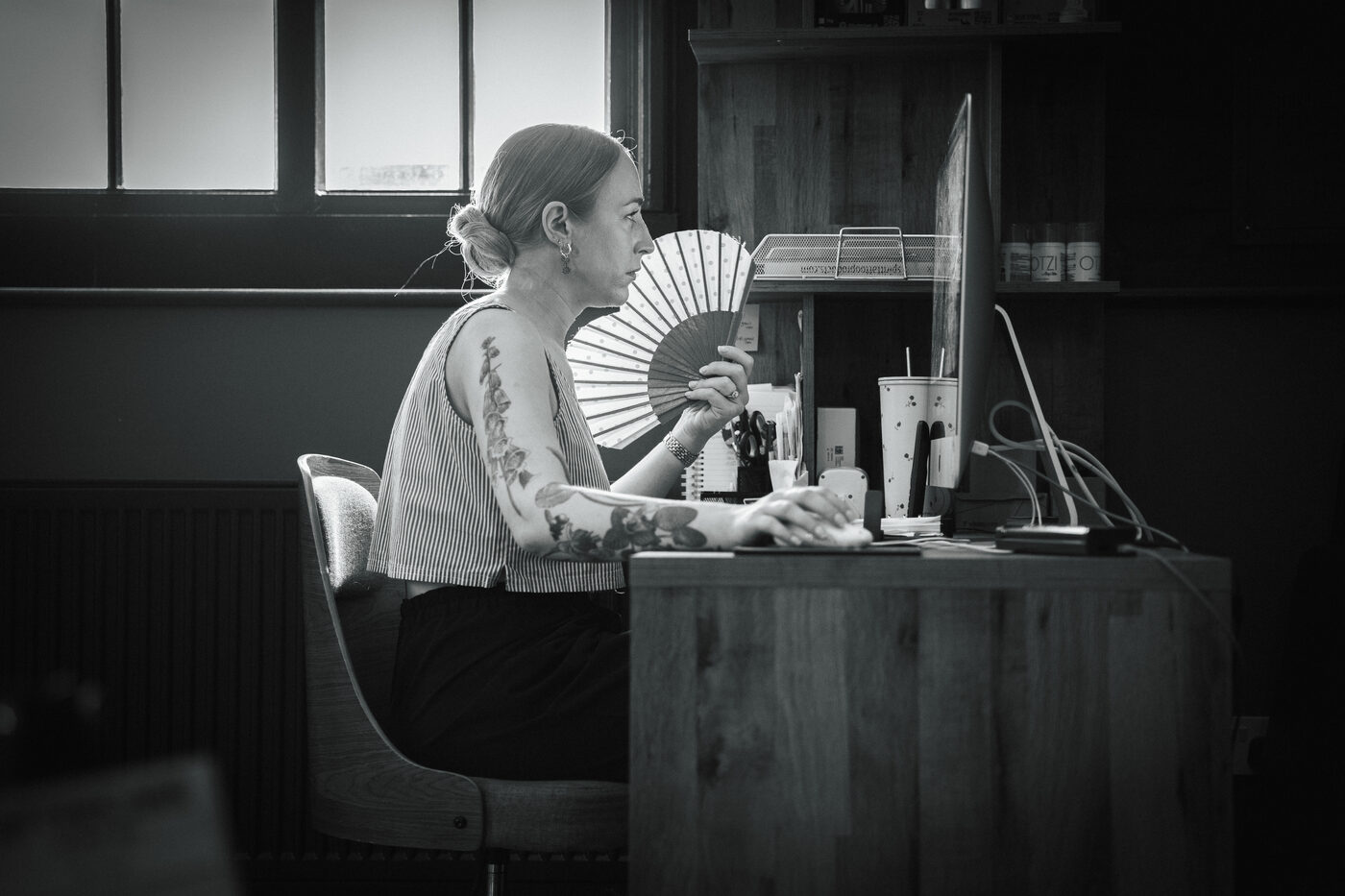 Black and white candid of studio life at The Church Tattoo.